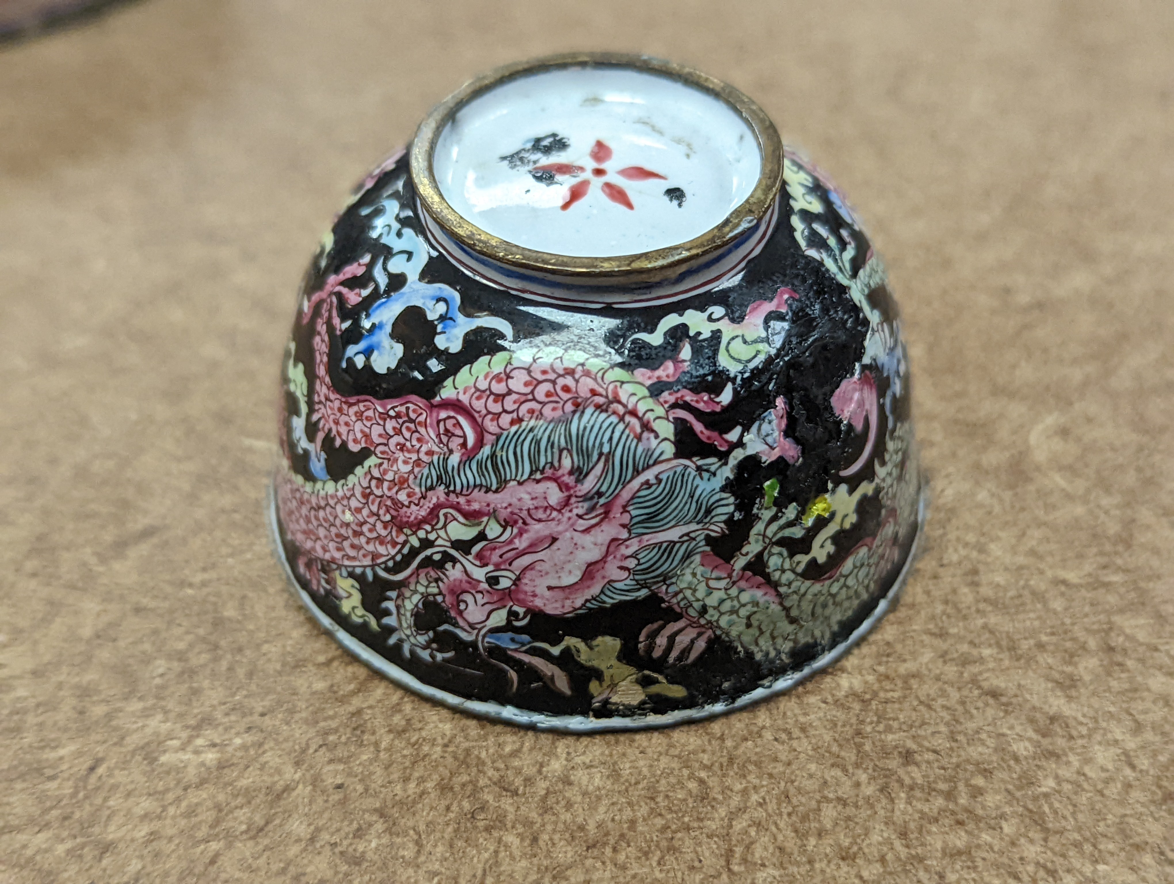 Two 18th century Chinese Canton enamel cups, and a 19th century Canton enamel oval snuff box, 5.8cm